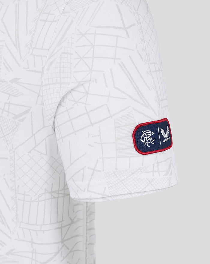Close up of T shirt fabric showing geometric print and Castore emblem near the hem