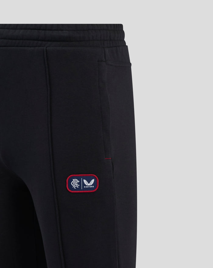 Close up of black Rangers FC lifestyle jogger fabric with elastic waistband and dual branded badge on the left thigh