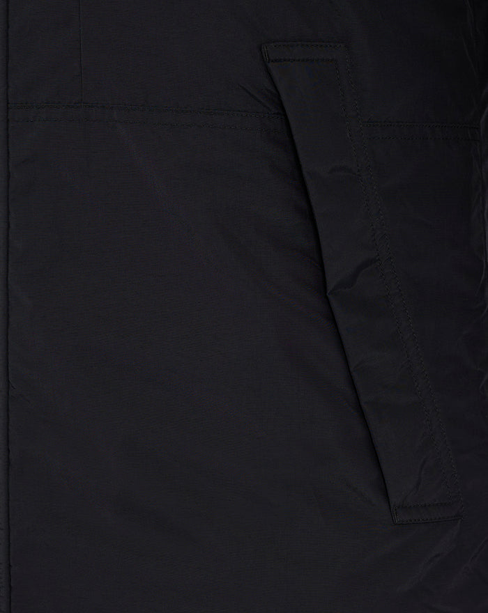 Close-up of black men's winter jacket fabric showing a pocket flap and strap detail on the side