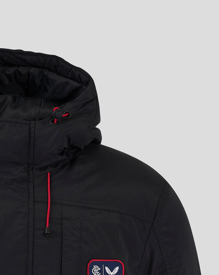 Detail of black hooded jacket with red drawstrings and stitched chest panels.