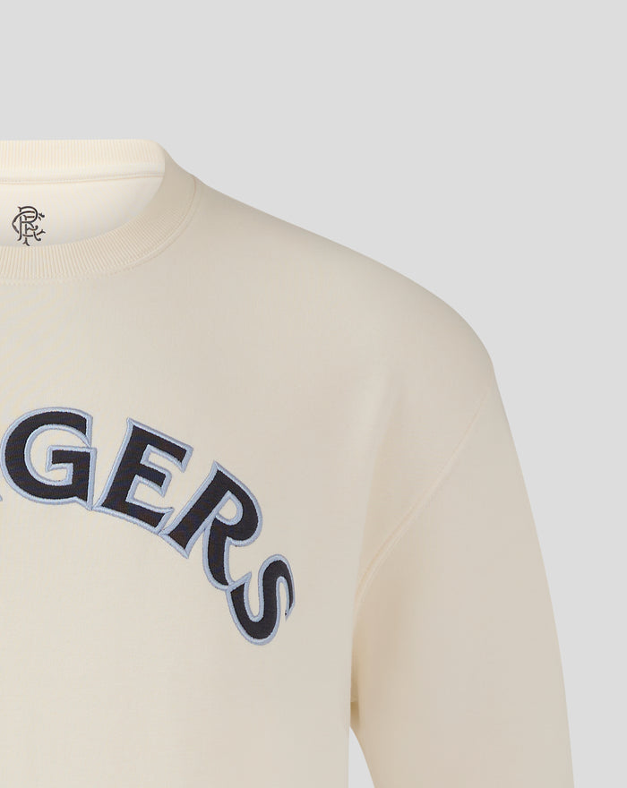 Close up of cream Rangers FC sweatshirt featuring bold large arched Rangers lettering across the chest