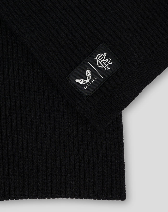 Close-up of black Rangers Club scarf highlighting a sewn rectangular patch with Castore logo and club crest