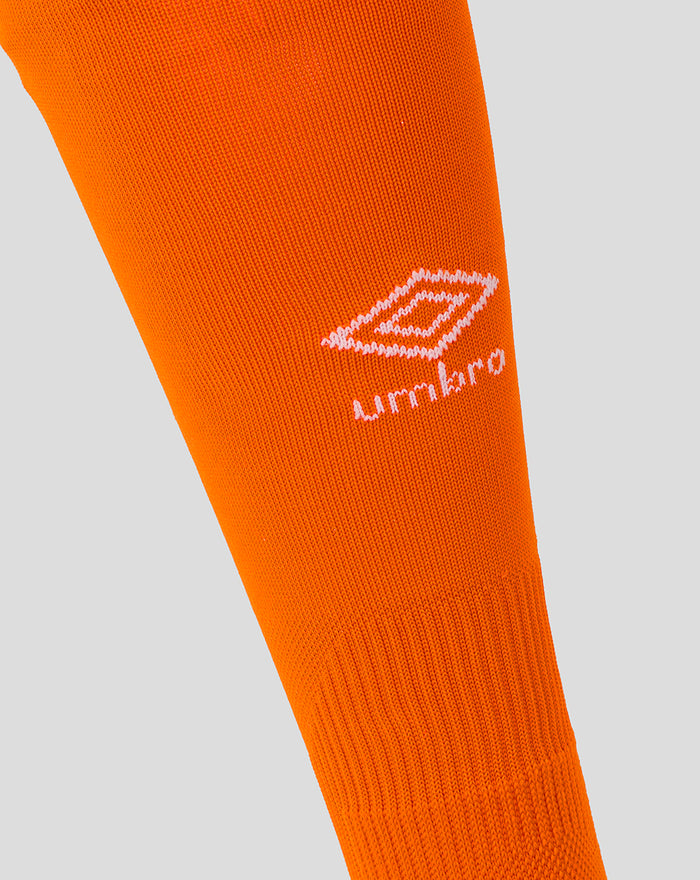 Close up of bright orange junior goalkeeper sock with white Umbro logo.