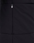 Close up of black padded jacket fabric with a center front zipper and stitched panel seams.