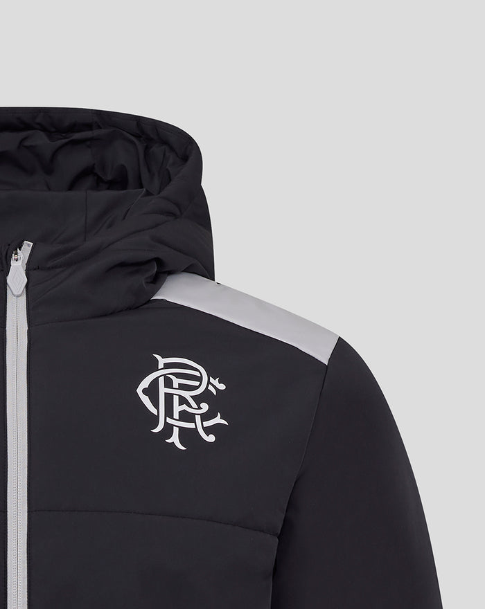 Close up of black padded coaches jacket showing hood white club crest on chest and gray shoulder panel