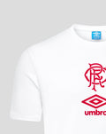 Close up of the front of the white junior travel short sleeve t-shirt showing the red Umbro logo and club crest near the chest