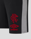 Close up of black shorts showing red crest and diamond Umbro logo at the hem with a grey side panel