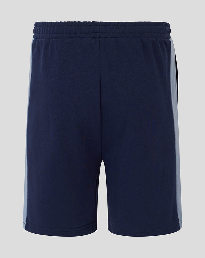 Back view of navy unisex travel shorts with elastic waistband and light side panels.
