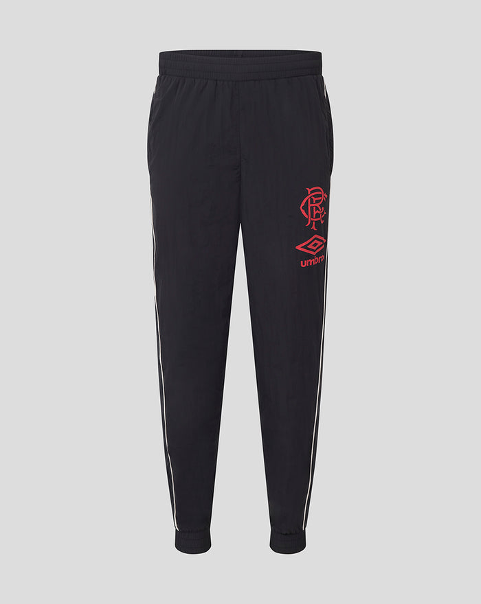 Unisex travel pants in black with white side piping and red club crest and Umbro logo