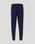 Back view of navy junior travel pants with elastic waistband ribbed cuffs and white piping down the sides