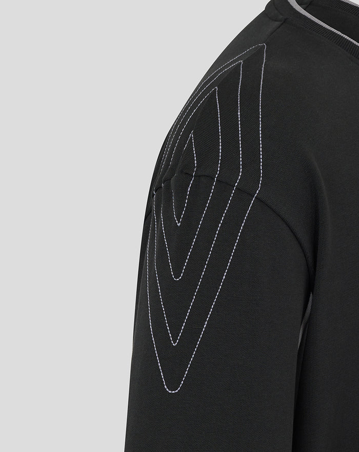 Close up of black travel crew sweatshirt showing white topstitching along the shoulder panel