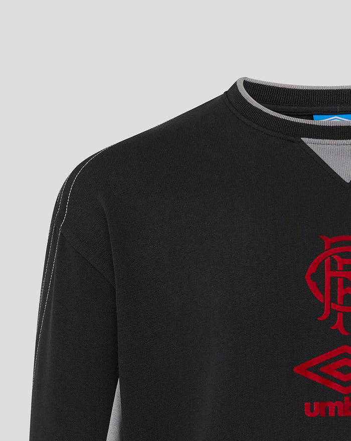 Black unisex travel crew sweatshirt with red club crest and reflective Umbro logo on the chest
