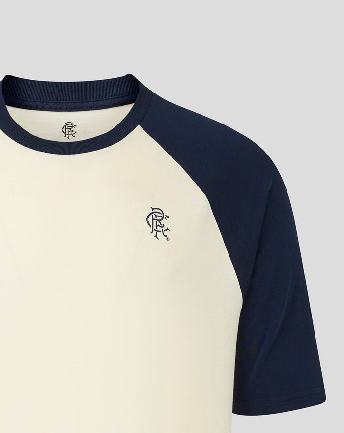 Close up of Rangers unisex raglan T shirt with navy sleeves and cream body, featuring a small crest on the chest.