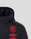 Front close-up of black travel jacket with hood, showing red crest and Umbro diamond logo on chest.