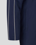 Close up of a navy travel bench jacket sleeve with white piping along the seam