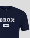 Unisex navy IBROX varsity tee close up at neckline with a small inner label and bold chest branding