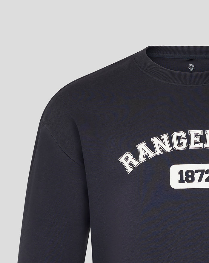 Close-up of navy Rangers FC sweatshirt showing arched logo and 1872 badge