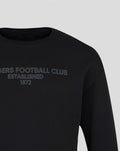 Close-up of black unisex varsity tonal typography crew sweatshirt with subtle grey lettering across the chest