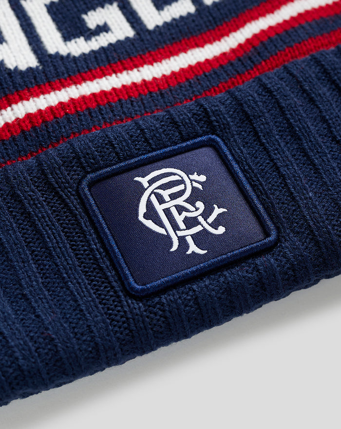 Close-up of navy Rangers knit beanie with white logo patch on the cuff