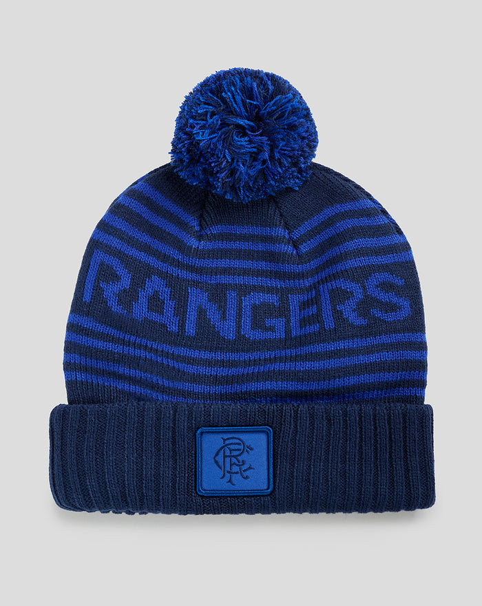 Blue Rangers knitted beanie with a large pom-pom on top and bold striped pattern