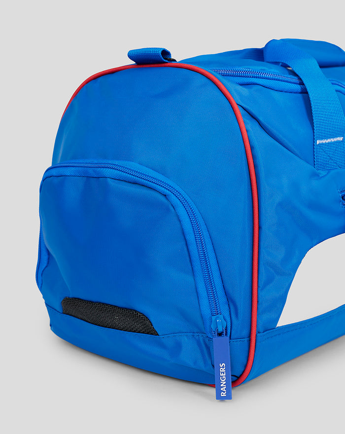 Side view of blue Rangers gym holdall with red piping along a curved seam and a zip pocket