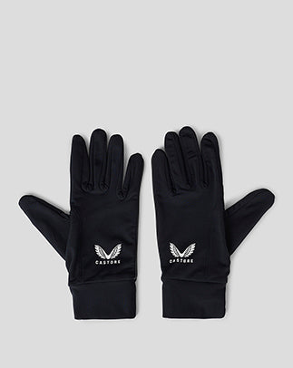 Pair of black unisex golf gloves with white Castore logos laid flat