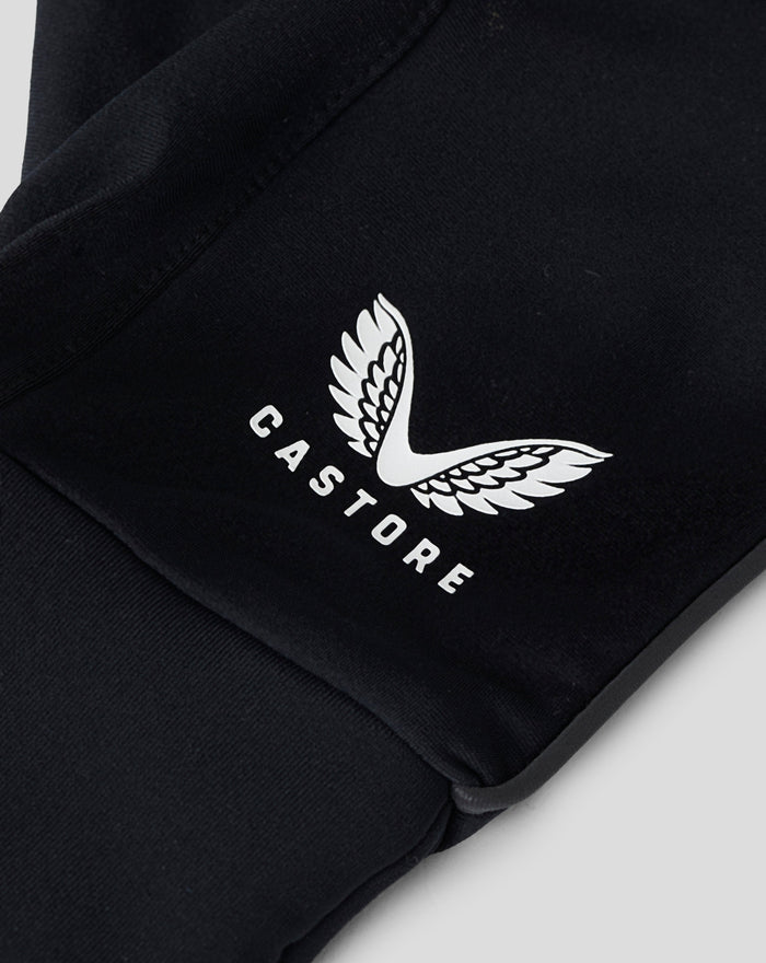 Close-up of black glove fabric with a white wing emblem