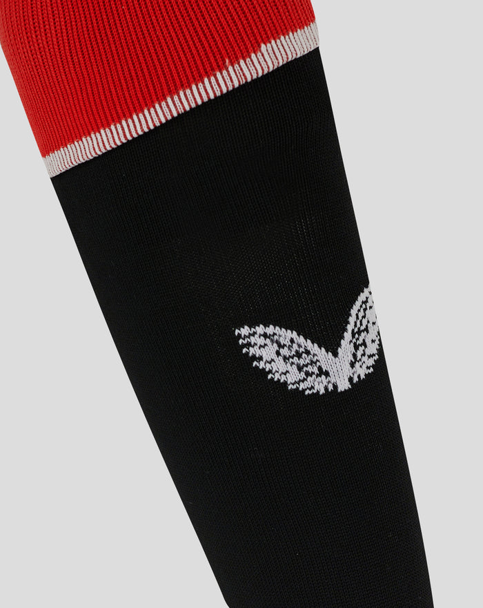 Close up of red cuff with white piping on a black Rangers sock highlighting contrast trim.