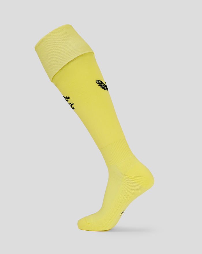 Yellow goalkeeper sock with folded cuff and small black crest at the ankle.