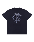Back of navy UNISEX 25/26 Art of T shirt showing a large ornate interwoven RFC emblem on the back with small text below.
