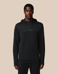 Front view of a man in a black flex hoodie with a small chest logo