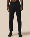 Man wearing black FLEX JOGGER pants with drawstring waist and tapered cuffs.