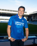 Man wearing blue unisex retro 2002-03 home shirt in a stadium