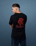 Back view of a man wearing a black Rangers X Art of T-shirt with a large red graphic on the back.