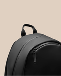 Close up of CORE BACKPACK top showing a grip handle and a CASTORE branded zipper pull.