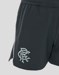 Side view of dark travel shorts with a large pale logo at the hem and piping along the side seam.