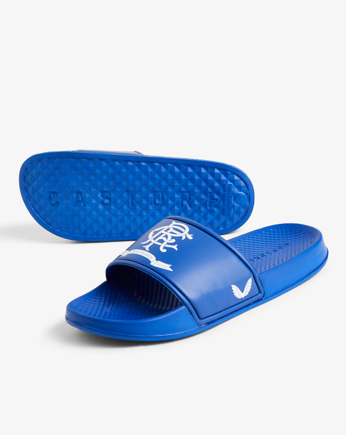 Bottom view of blue Rangers slider showing textured sole and Castore branding
